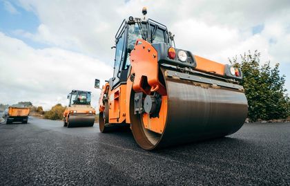 Mothetho Civils orange road rollers compacting fresh black tar on a Gauteng road project