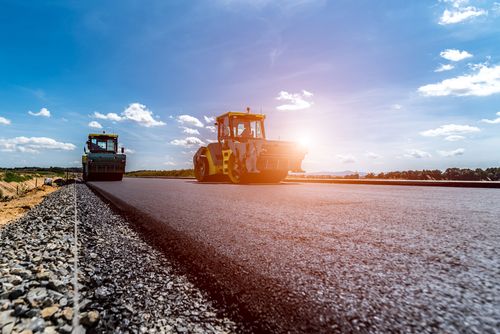 Mothetho Civils road rollers compacting fresh tar at sunset on a Gauteng road project